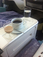 a cup of coffee and a glass of water on a table