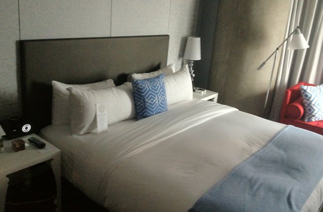 a bed with pillows and a lamp