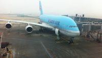 a blue airplane on a tarmac