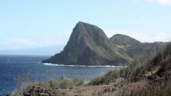 a rocky island with a body of water