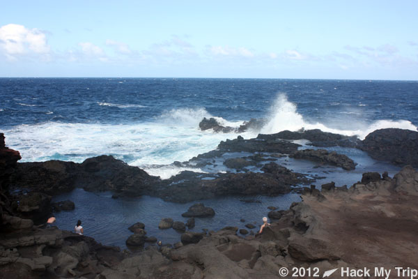 a rocky shore with waves crashing on it