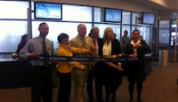 a group of people cutting a ribbon