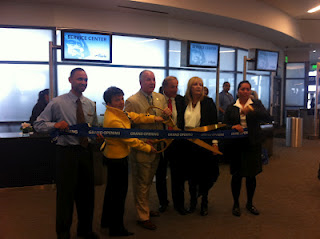 a group of people cutting a ribbon