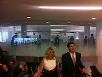 a man and woman walking in a building