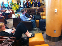 people sitting in chairs in a lobby
