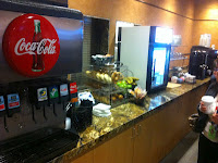 a counter with a soda machine and a drink dispenser