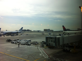 an airport with airplanes and vehicles