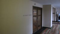 a hallway with a door and glass doors
