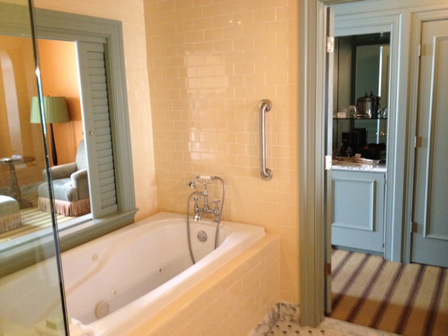 a bathroom with a bathtub and a mirror
