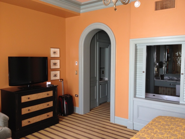 a room with a tv and a dresser