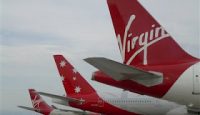 a group of airplanes parked at an airport