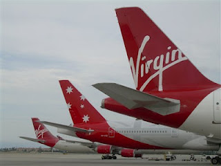 a group of airplanes parked at an airport