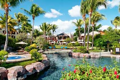 a pool with palm trees and buildings