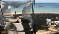 a beach bed with a canopy on the beach