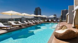 a pool with chairs and umbrellas