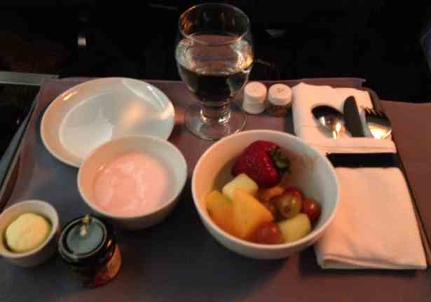 a bowl of fruit and yogurt on a table