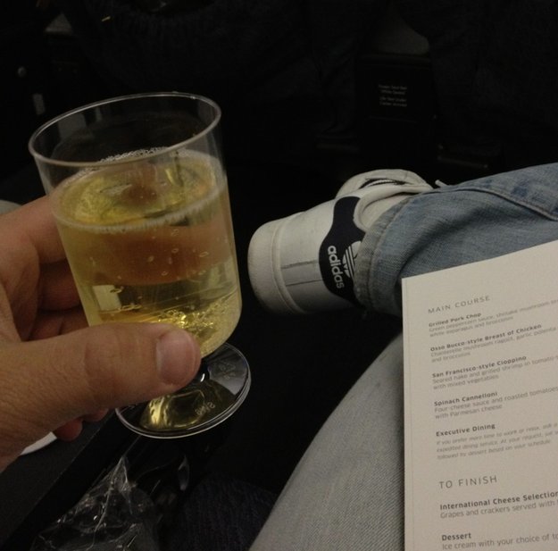 a hand holding a glass of liquid