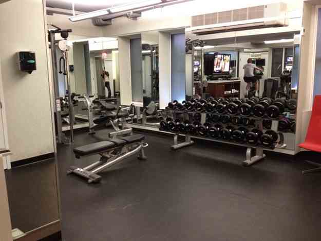 a gym with weights and a mirror