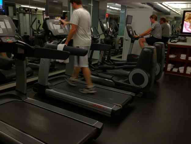 people in a gym with treadmills