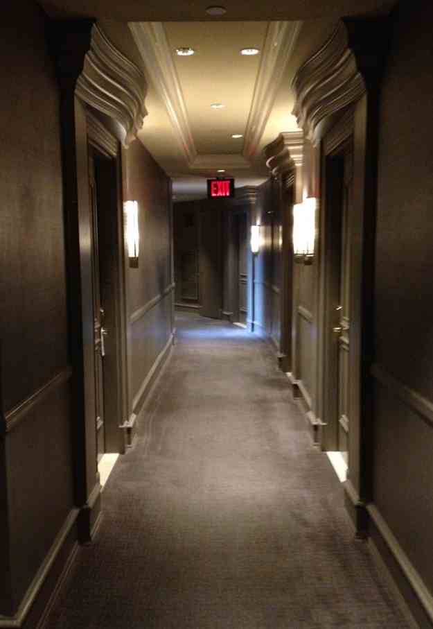 a hallway with a sign on the wall