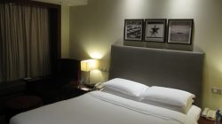 a bed with white sheets and pillows
