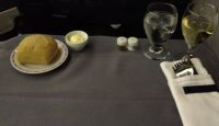 a plate of bread and two glasses of wine