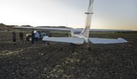 a group of people standing around a plane