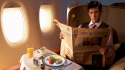 a man reading a newspaper on an airplane