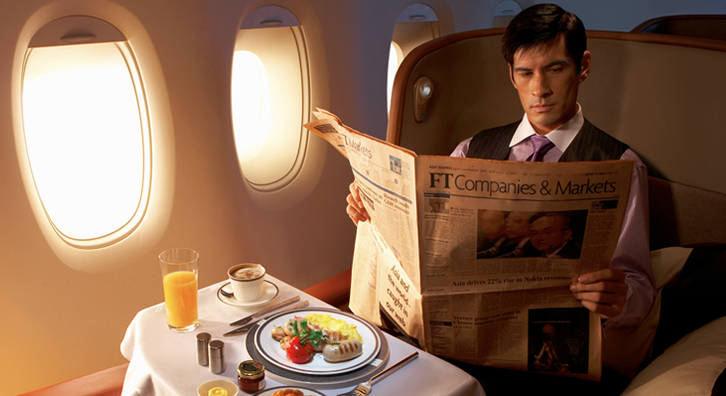 image of man flying in first class