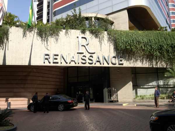 a building with a sign and cars parked in front of it
