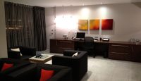 a room with a desk and couches