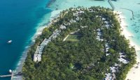 an island with a group of houses and a beach