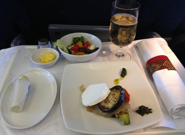 a plate of food and a glass of wine