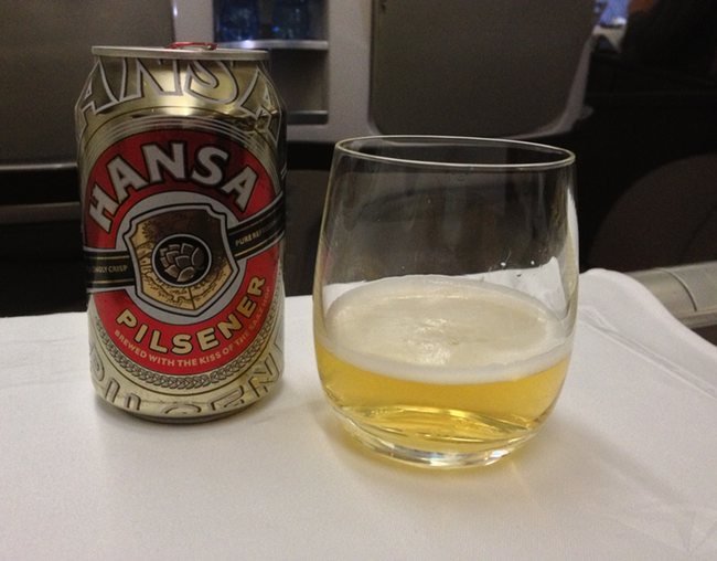 a can of beer next to a glass of beer