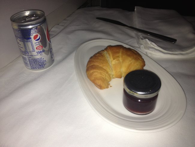 a croissant and jam on a plate