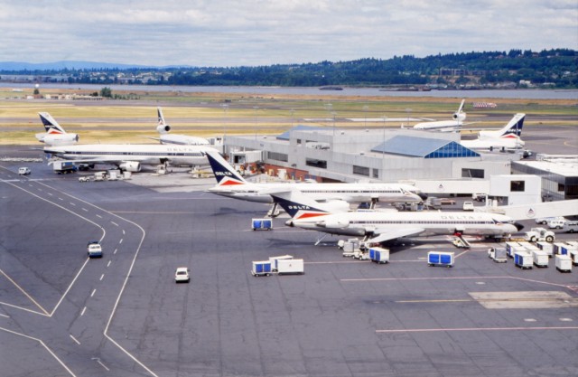 a group of airplanes at an airport