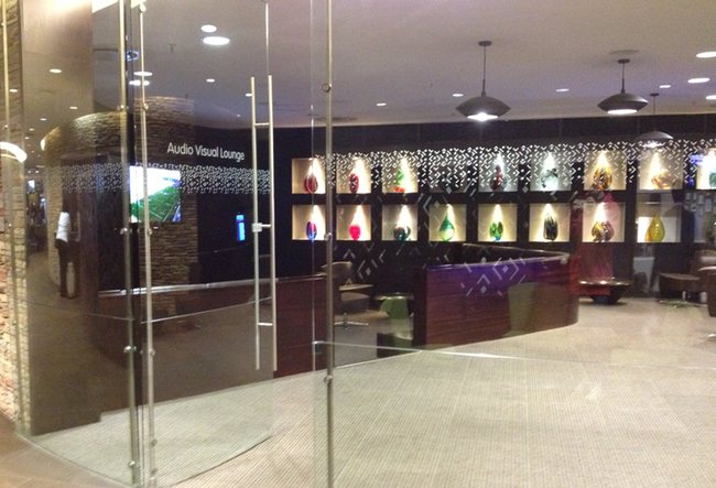 a glass door with a sign on the wall