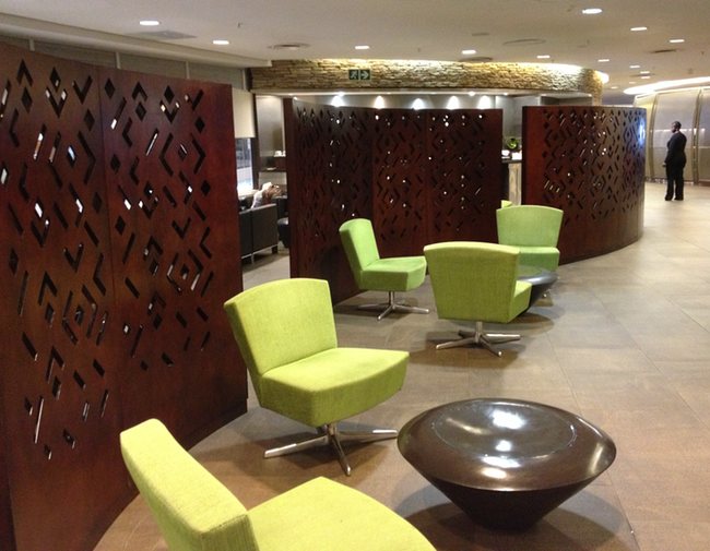 a room with green chairs and a table