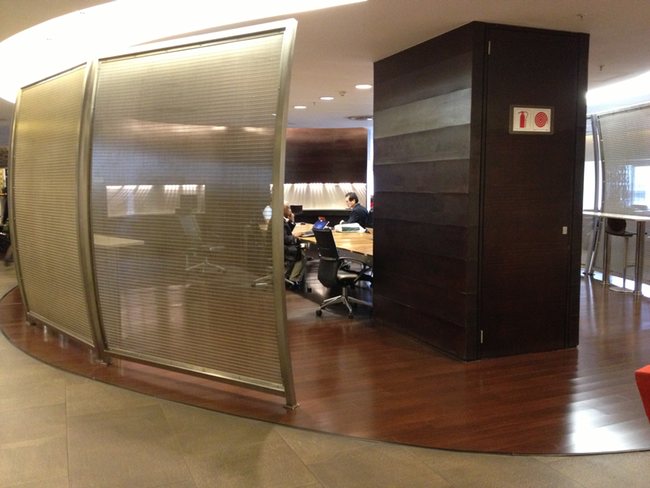 a room with a glass wall and a table