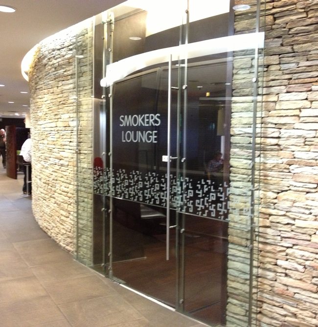 a glass door with a sign on the side of a building