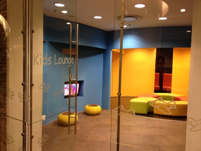 a glass door with a group of chairs and a tv