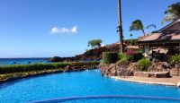 a pool with a house and a beach