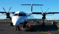 a man standing next to a plane