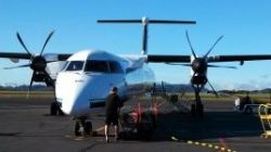 a man standing next to a plane