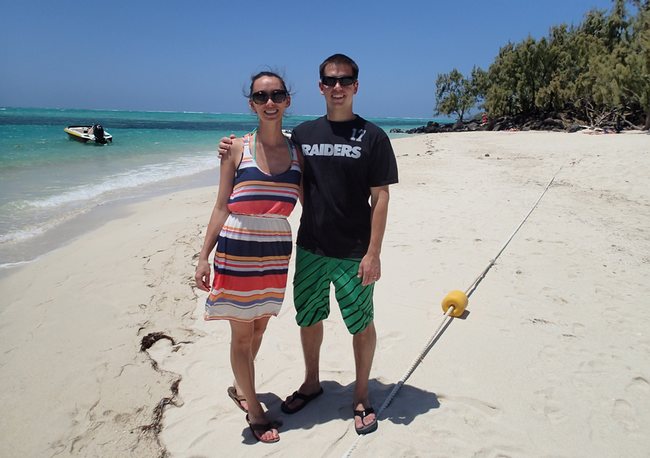 a man and woman standing on a beach