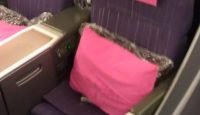 a seat with pink pillows on it