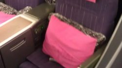 a seat with pink pillows on it