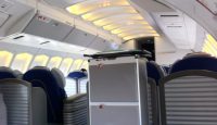 an airplane with blue seats and a refrigerator