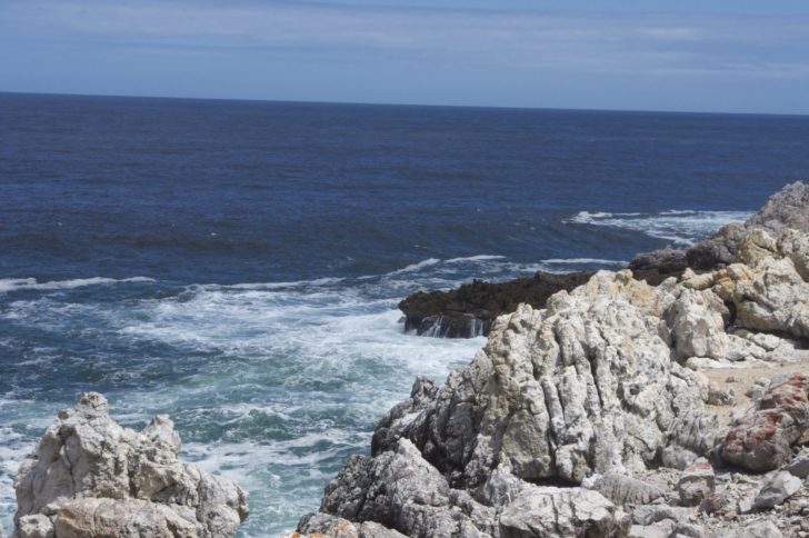 a rocky shore with waves crashing on the rocks