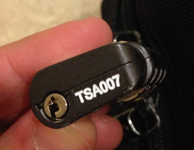 a person holding a small black object with white text